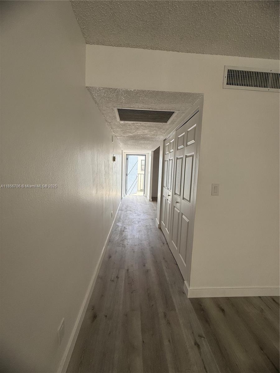 20200 West Country Club Drive, Unit PH14 Aventura, FL 33180 - Photo 15 of 15 a view of a hallway with wooden floor