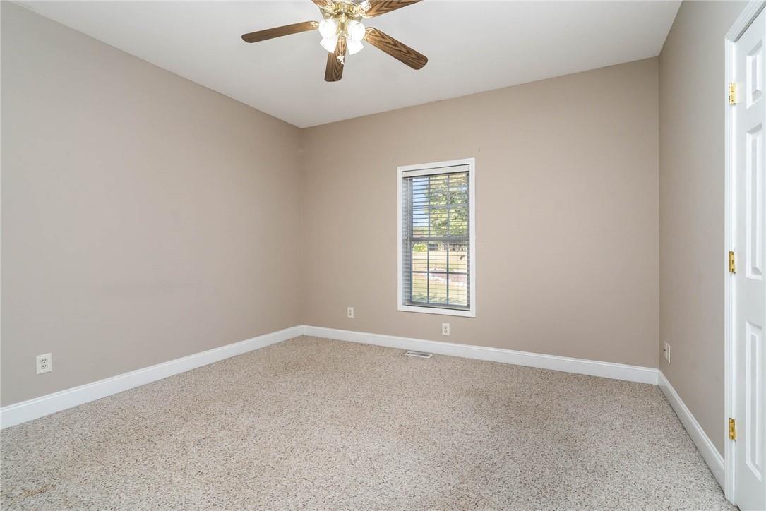 166 Louie Hicks Road Pageland, SC 29728 - Photo 22 of 30 an empty room with a window and a ceiling fan