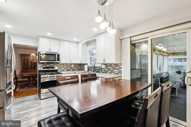 a kitchen with kitchen island a sink stove and refrigerator
