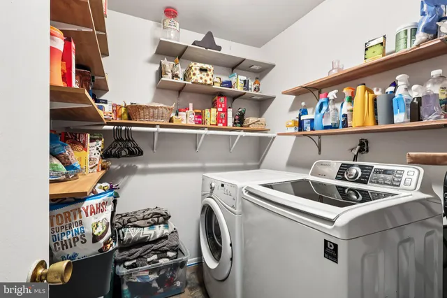 a utility room with dryer washer and other items