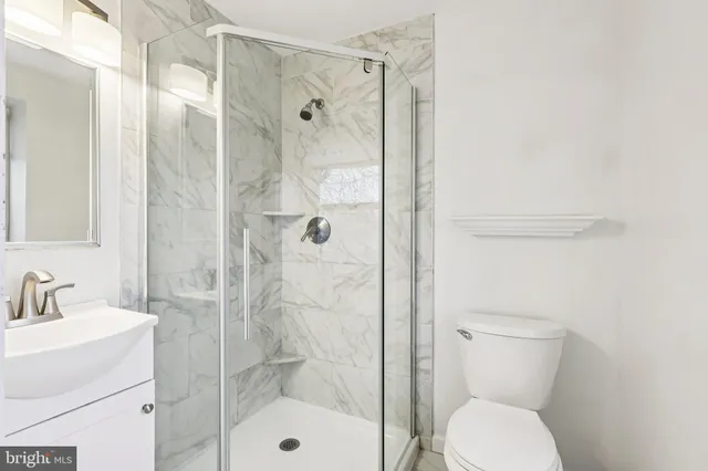 a bathroom with a toilet and shower