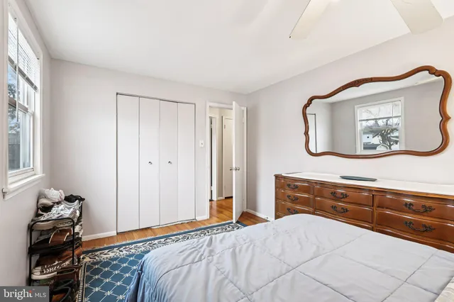 a bedroom with a bed and a mirror on dresser