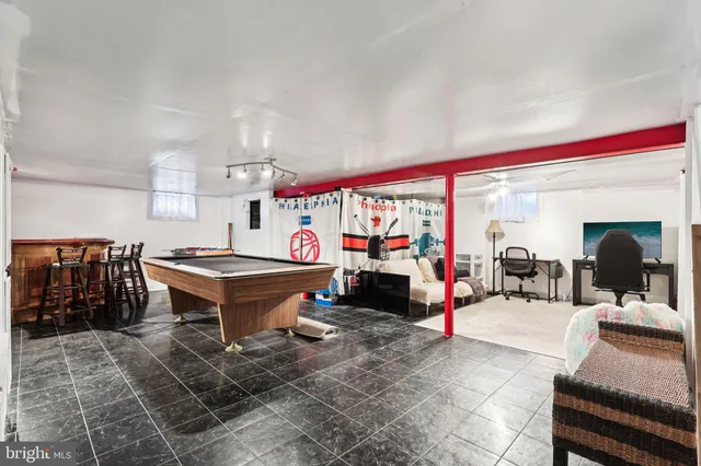 a living room with furniture a pool table and a large window
