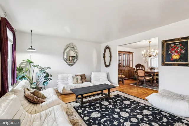 a living room with furniture a rug and a window