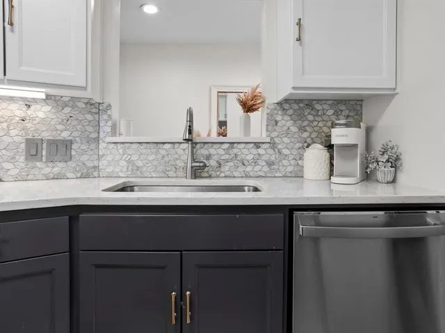 a kitchen with a sink and cabinets
