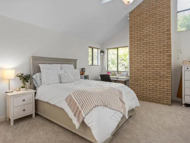 a bedroom with a bed dresser and a window