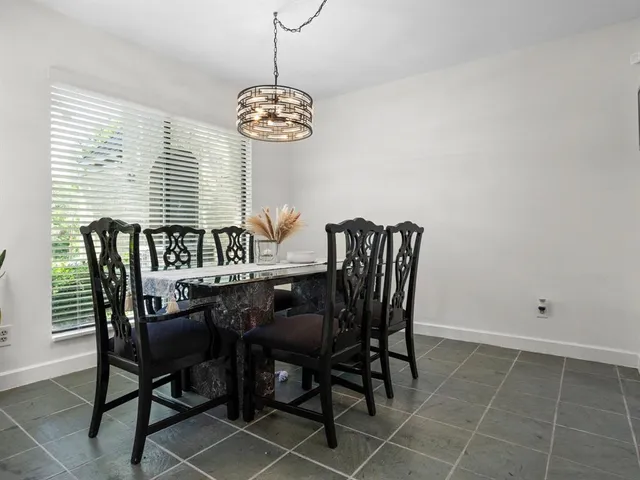 a view of a dining room with furniture and chandelier