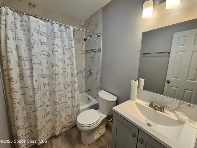 a bathroom with a toilet sink and shower