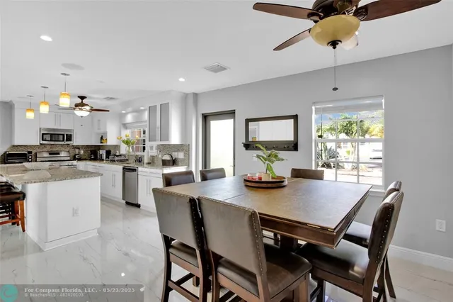a view of a dining room with furniture and a window