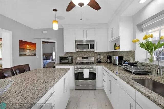 a kitchen with a stove cabinets and microwave