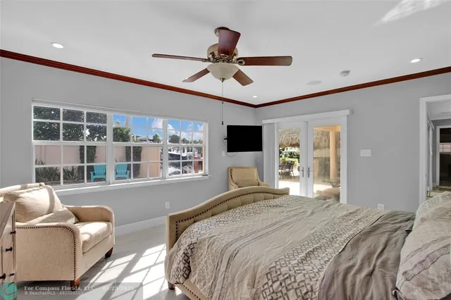 a bedroom with a bed couch and a window