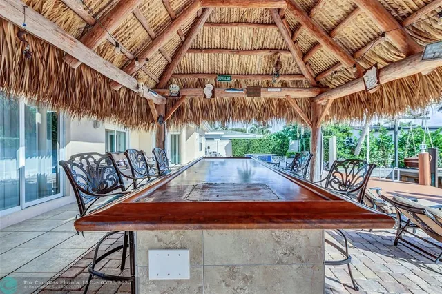 a backyard of a house with barbeque oven table and chairs