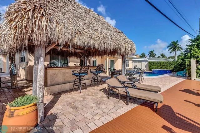 a view of a patio with table and chairs with wooden fence and plants