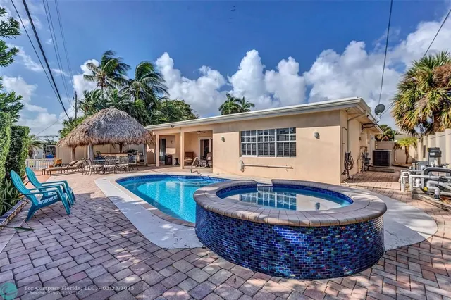 a front view of house with swimming pool and porch