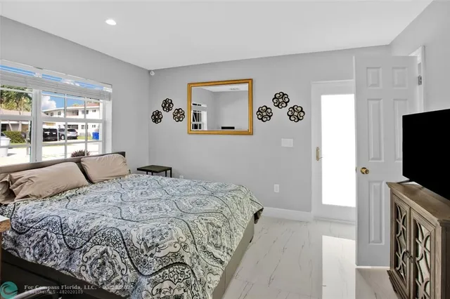 a bedroom with a bed and a flat screen tv