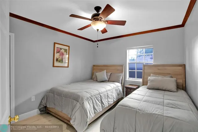 a bedroom with two beds and a chandelier
