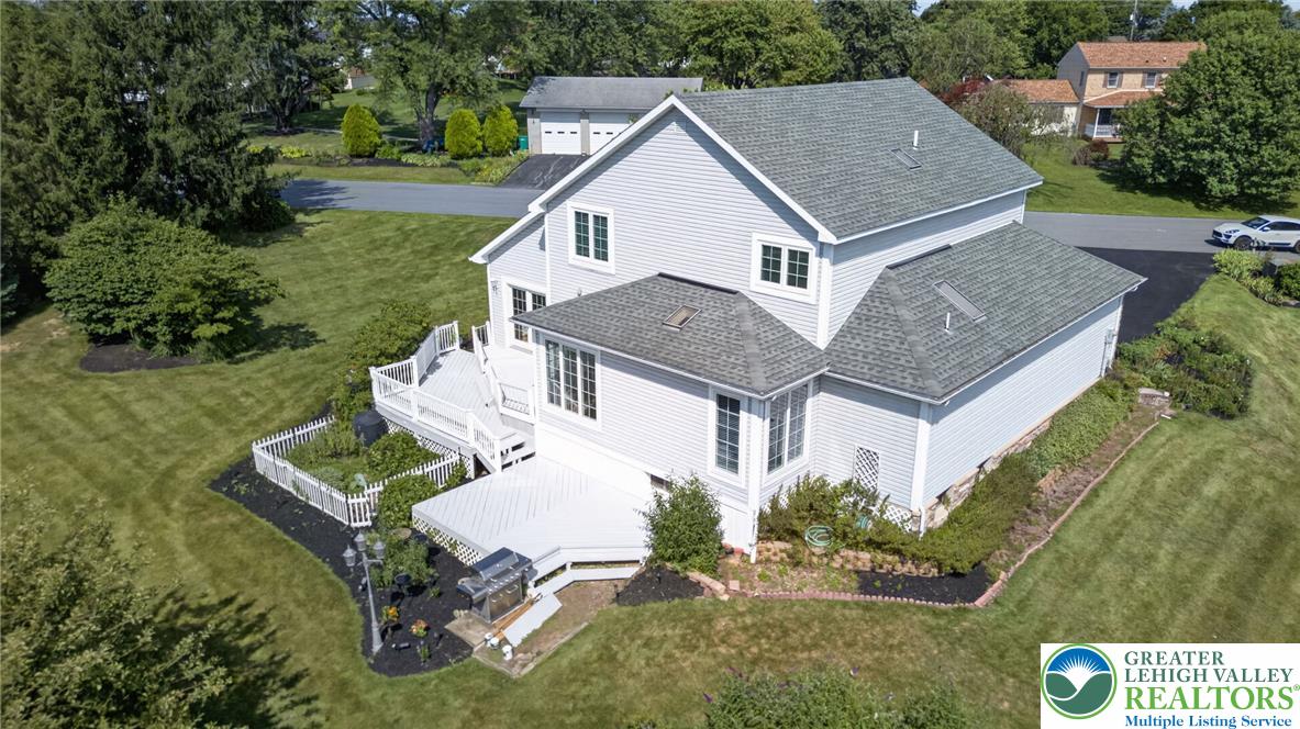 6467 Abbey Road Wind Gap, PA 18091 - Photo 3 of 46 An aerial perspective reveals a charming home with an expansive multi-level deck and lush landscaping.
