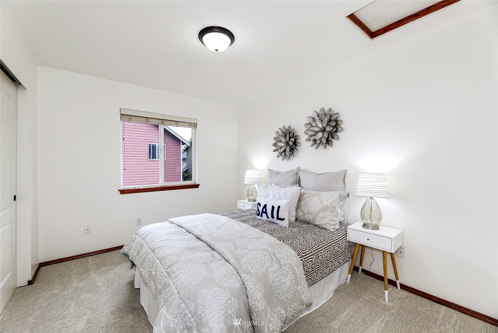131 197th Street Southwest Bothell, WA 98012 - Photo 22 of 27 a bedroom with a bed and a painting on the wall