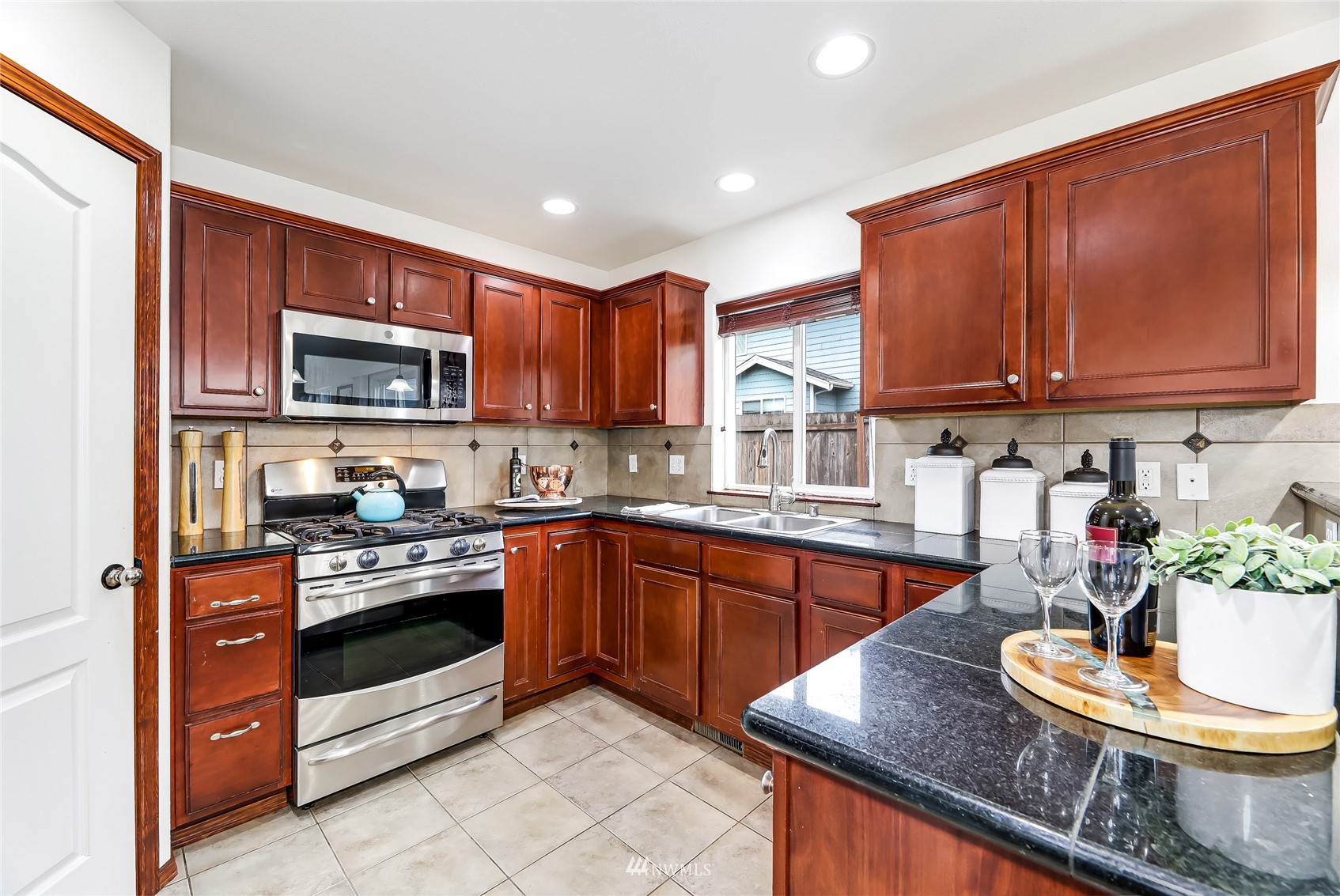 131 197th Street Southwest Bothell, WA 98012 - Photo 10 of 27 a kitchen with stainless steel appliances granite countertop a stove sink and cabinets