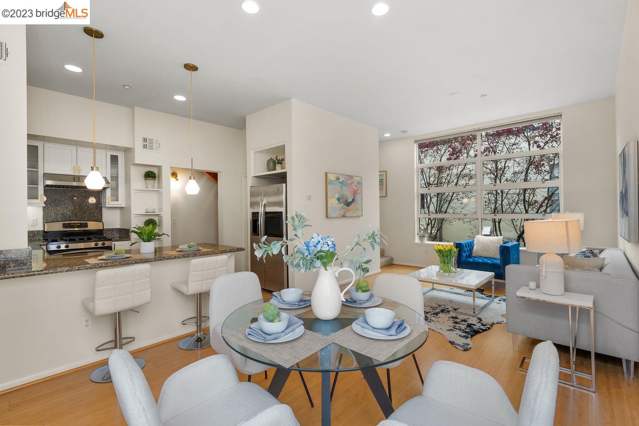 a dining room with furniture a large window and a dining table