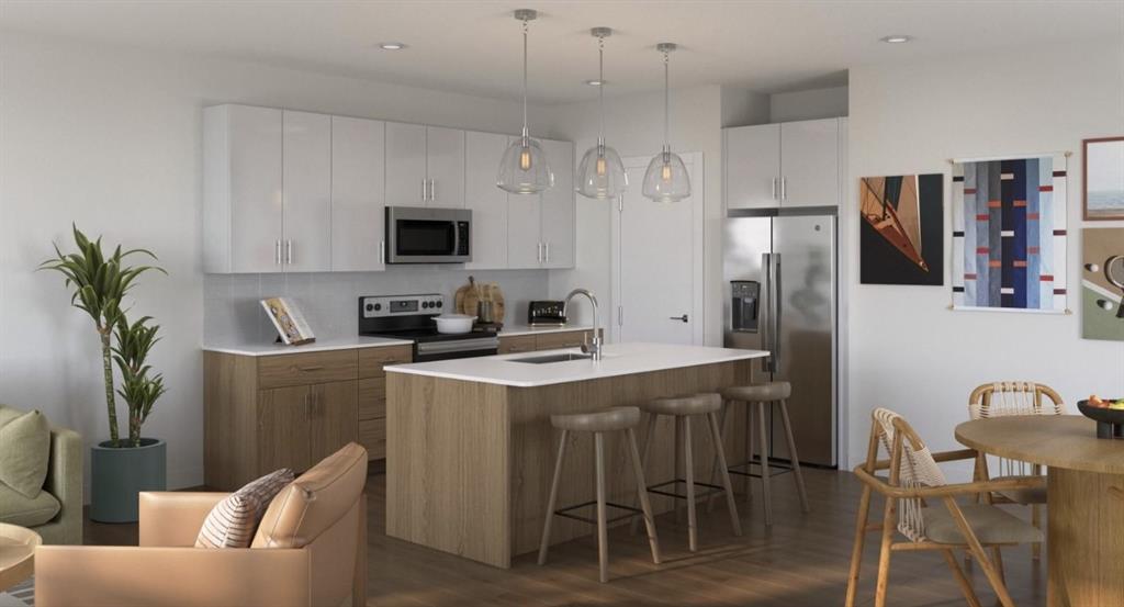 9032 Prairie Path, Unit 8929 Rowlett, TX 75089 - Photo 8 of 28 Kitchen featuring stainless steel appliances, a kitchen breakfast bar, hanging light fixtures, dark wood-style flooring, and recessed lighting