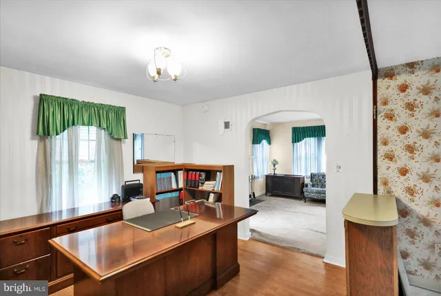a living room with furniture a fireplace and a chandelier