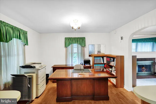 a view of kitchen with stainless steel appliances granite countertop a stove and a wooden floor