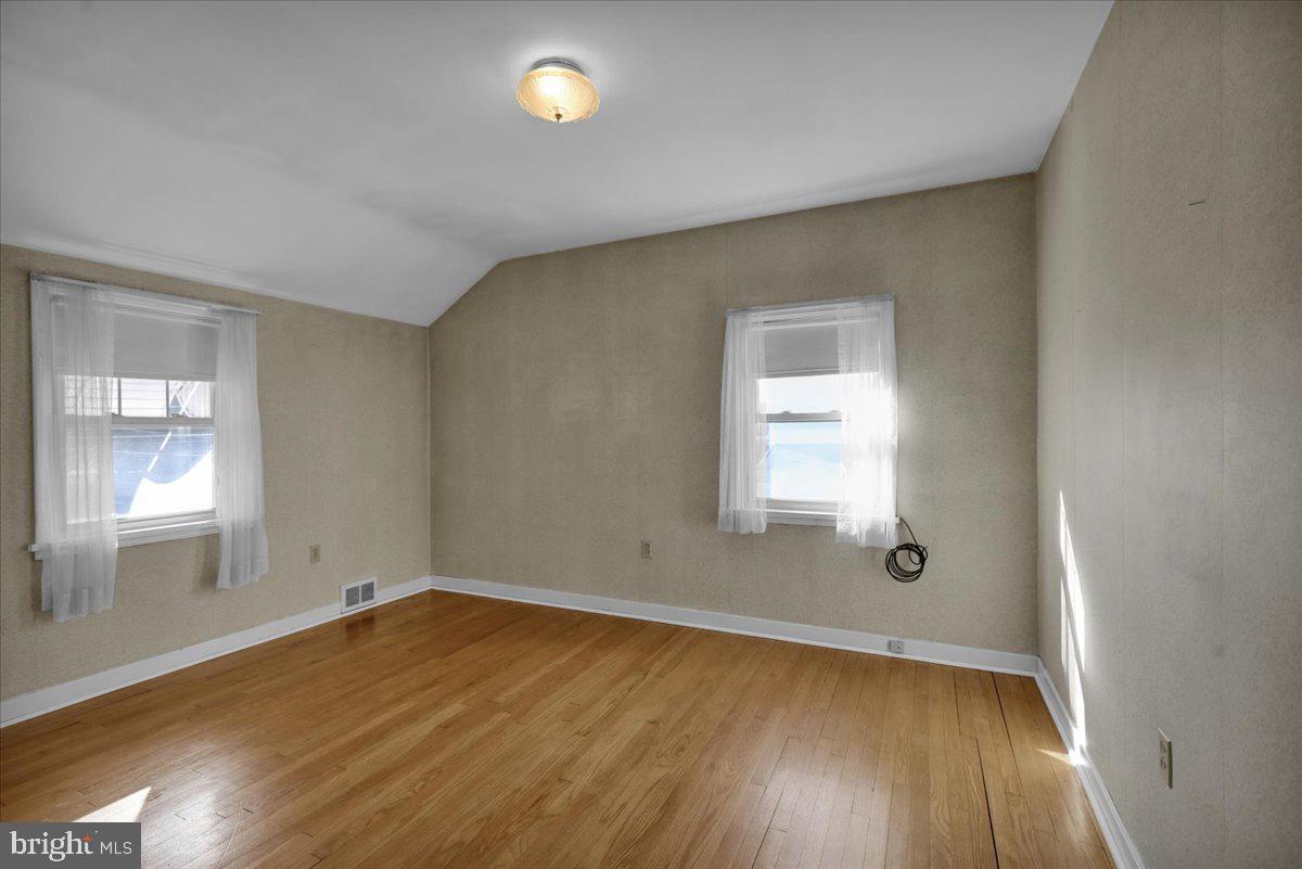 1510 Garfield Avenue Wyomissing, PA 19610 - Photo 14 of 26 an empty room with wooden floor and windows