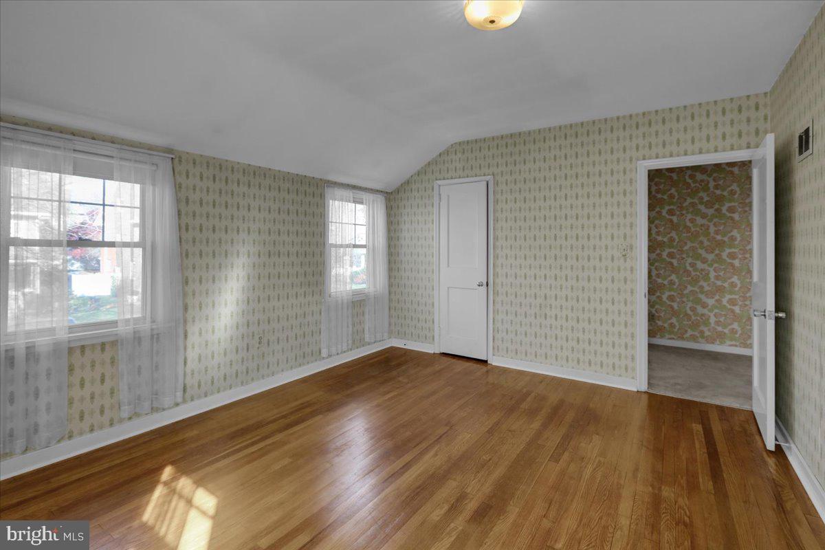 1510 Garfield Avenue Wyomissing, PA 19610 - Photo 17 of 26 an empty room with wooden floor and windows