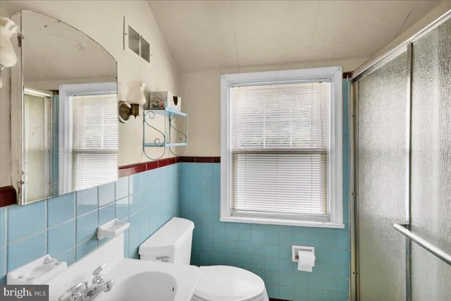 a bathroom with a toilet sink and shower