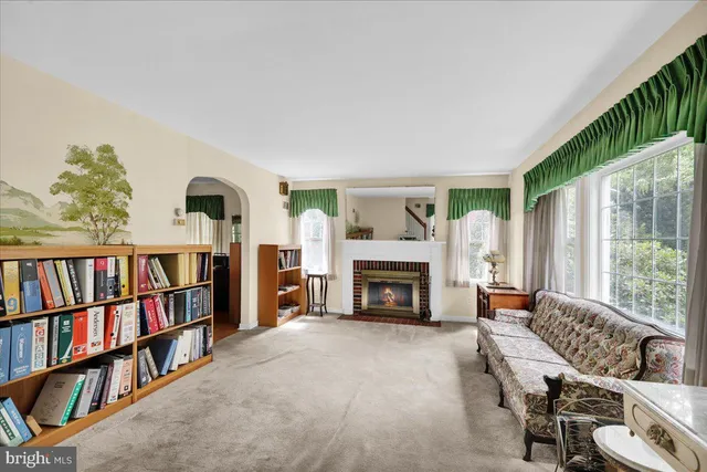 a living room with furniture and a book shelf
