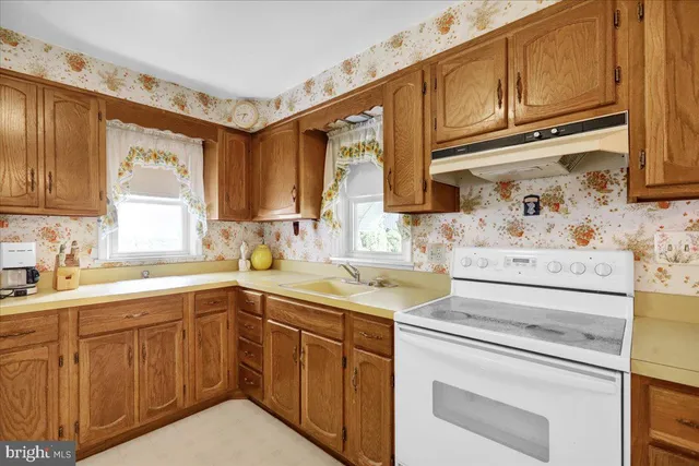 a kitchen with a sink stove and cabinets