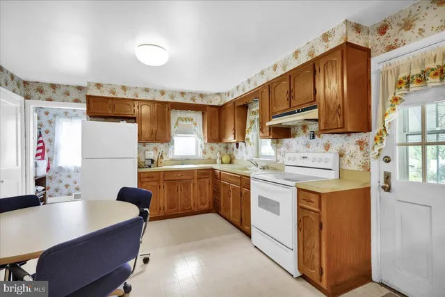 a kitchen that has a sink and a stove in it