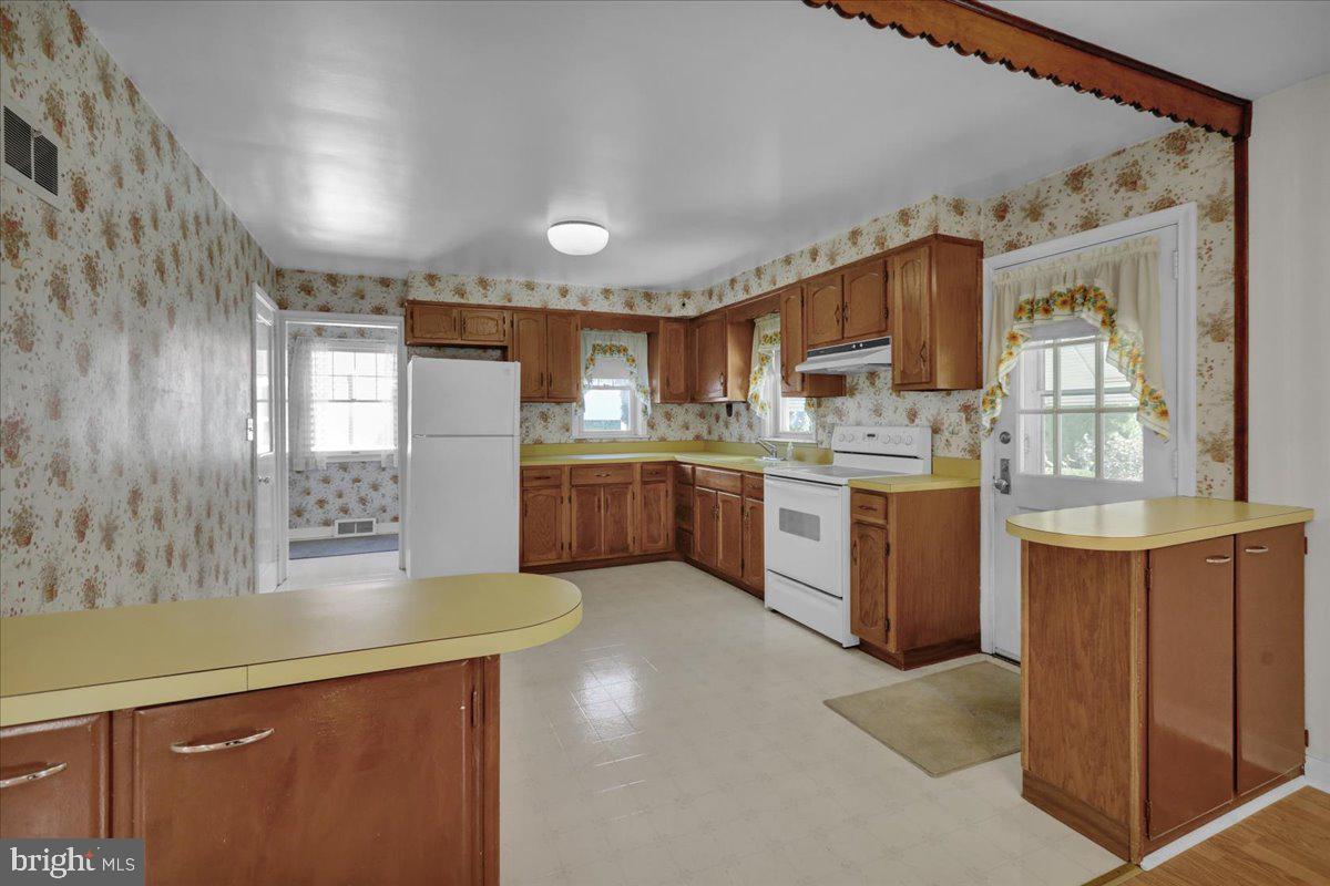 1510 Garfield Avenue Wyomissing, PA 19610 - Photo 7 of 26 a kitchen with stainless steel appliances granite countertop a stove a sink dishwasher and a refrigerator