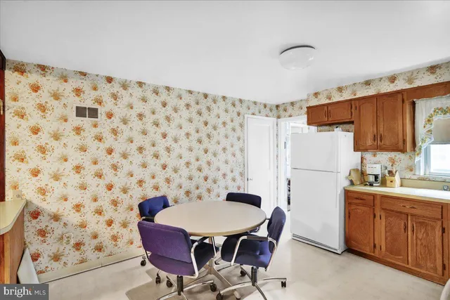a kitchen with a cabinets and chairs