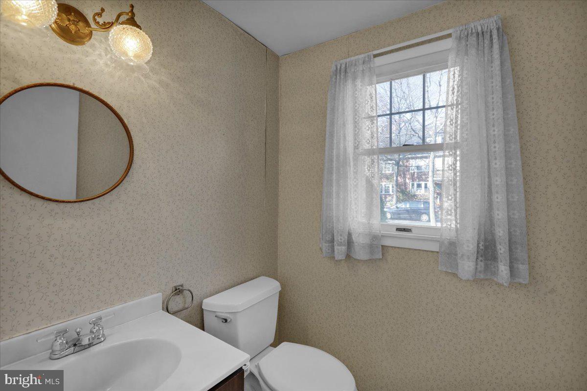 1510 Garfield Avenue Wyomissing, PA 19610 - Photo 10 of 26 a bathroom with a toilet sink and mirror