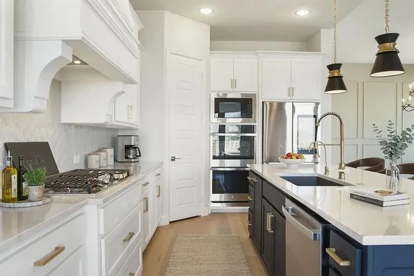 a kitchen with stainless steel appliances a sink stove and refrigerator