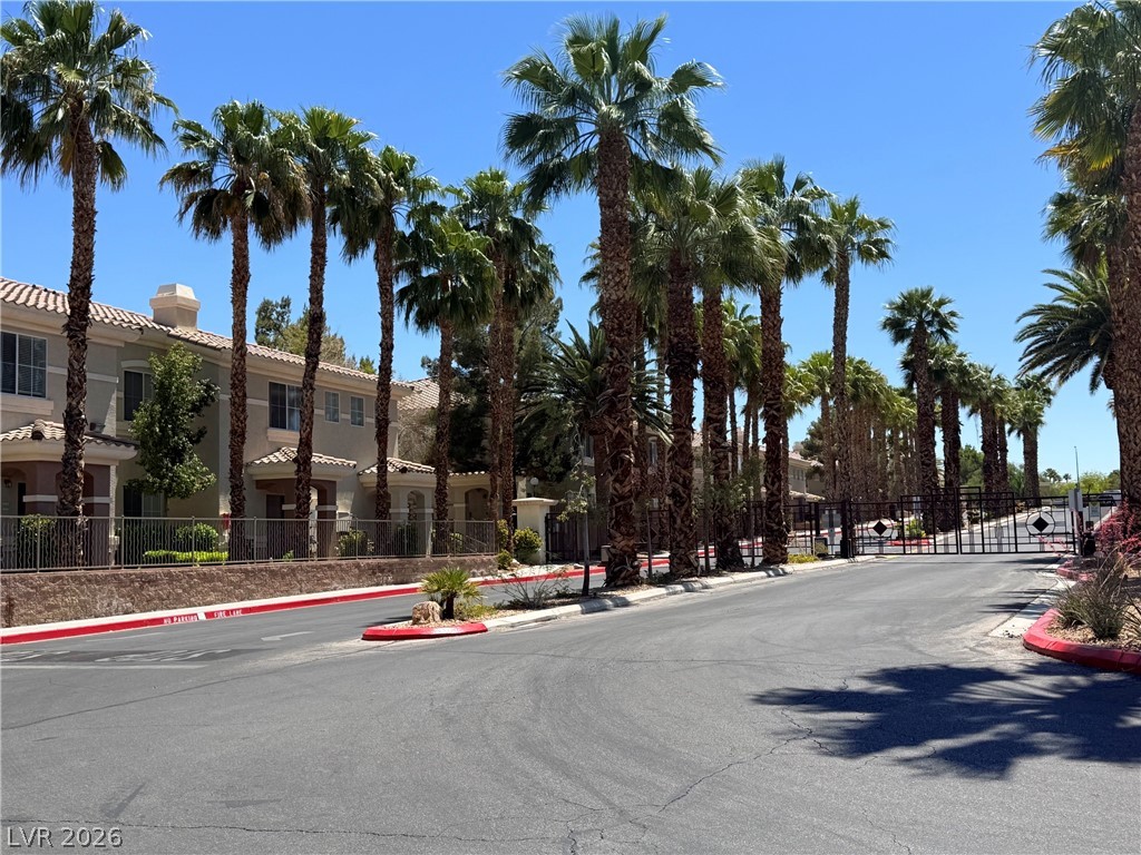 9050 West Warm Springs Road, Unit 2002 Las Vegas, NV 89148 - Photo 4 of 46 This serene neighborhood entry boasts lush palms and meticulously maintained community grounds.