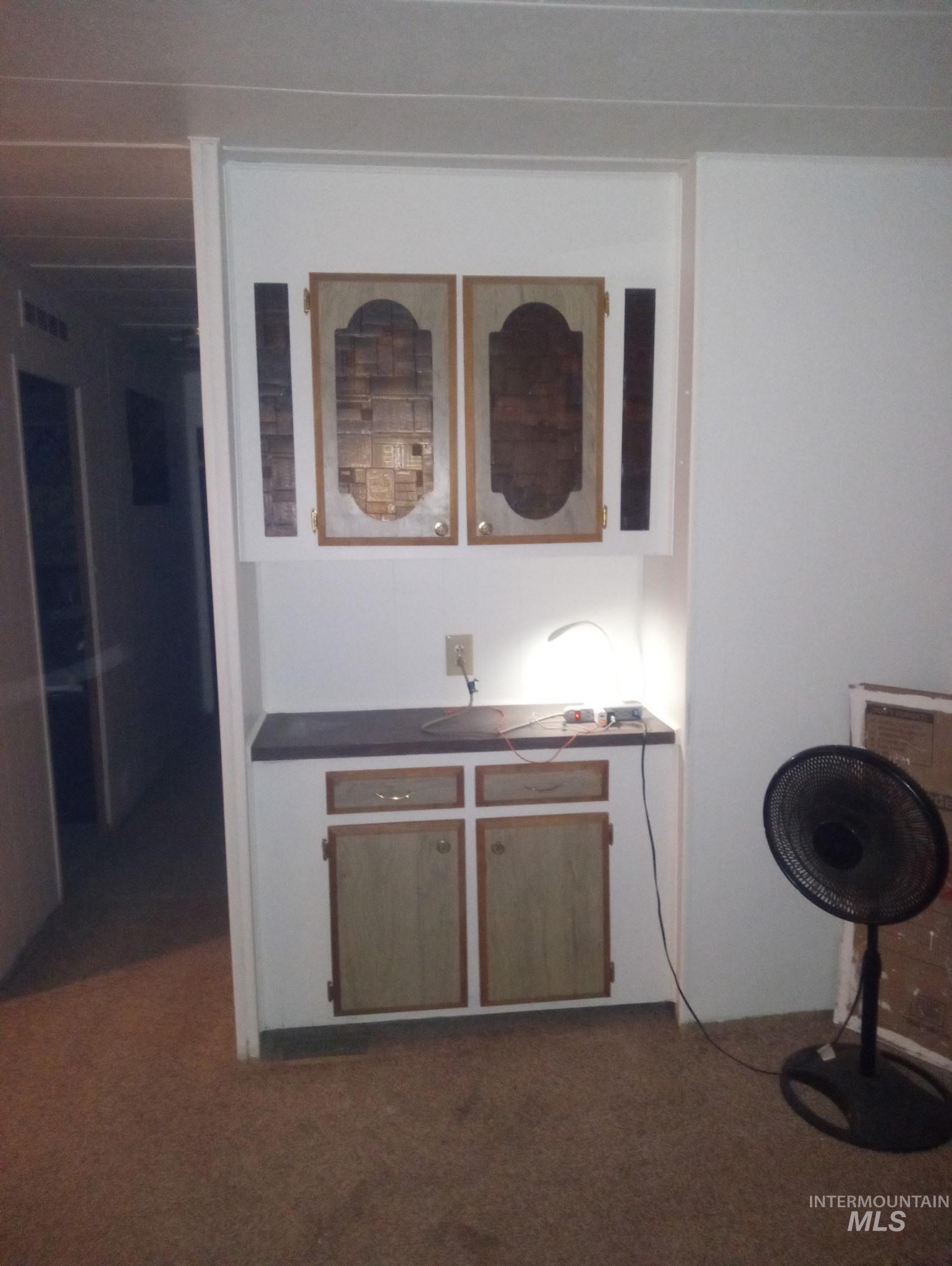 749 Ritter Avenue Vale, OR 97918 - Photo 22 of 28 Bar area with dark countertops, dark colored carpet, and white cabinetry