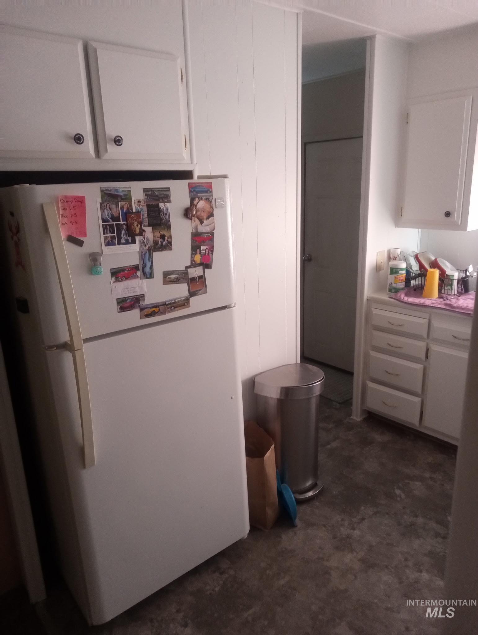 749 Ritter Avenue Vale, OR 97918 - Photo 25 of 28 Kitchen with white cabinetry, freestanding refrigerator, and light countertops