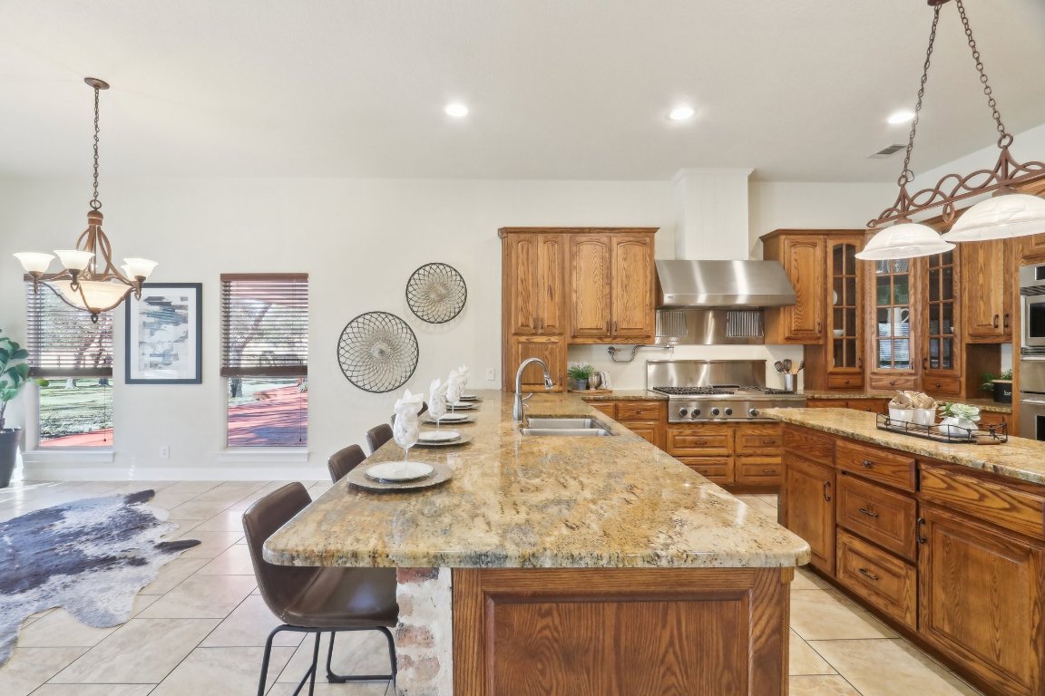 294 Logan Ranch Road Georgetown, TX 78628 - Photo 11 of 39 a dining hall with stainless steel appliances granite countertop a sink a stove and chairs