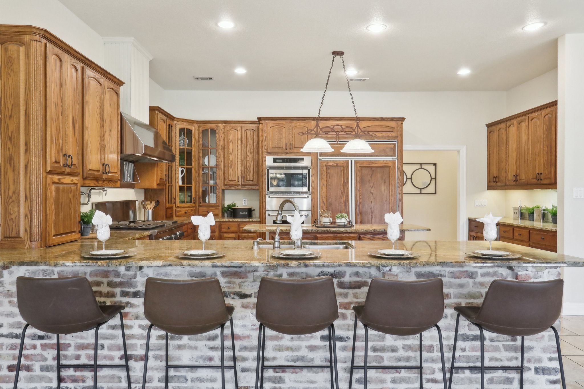 294 Logan Ranch Road Georgetown, TX 78628 - Photo 14 of 40 a kitchen with stainless steel appliances granite countertop a kitchen island a stove and a cabinets