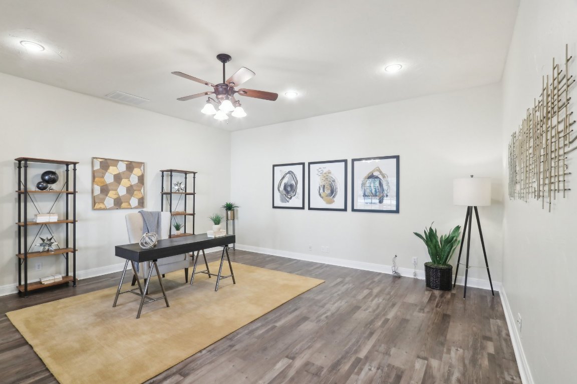 294 Logan Ranch Road Georgetown, TX 78628 - Photo 17 of 39 a living room with furniture and a wooden floor