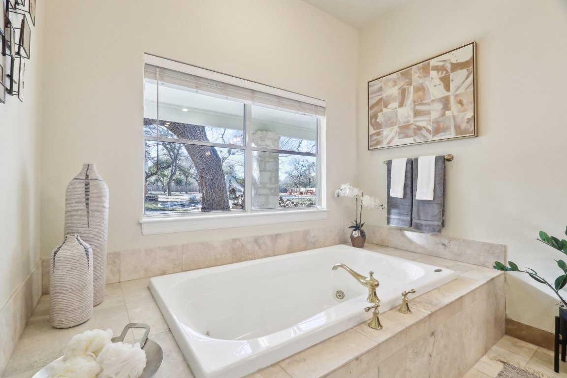 294 Logan Ranch Road Georgetown, TX 78628 - Photo 20 of 39 a bath tub sitting next to a window
