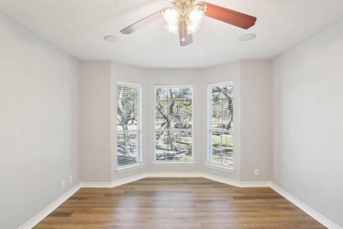 294 Logan Ranch Road Georgetown, TX 78628 - Photo 24 of 39 a view of an empty room with wooden floor and a window