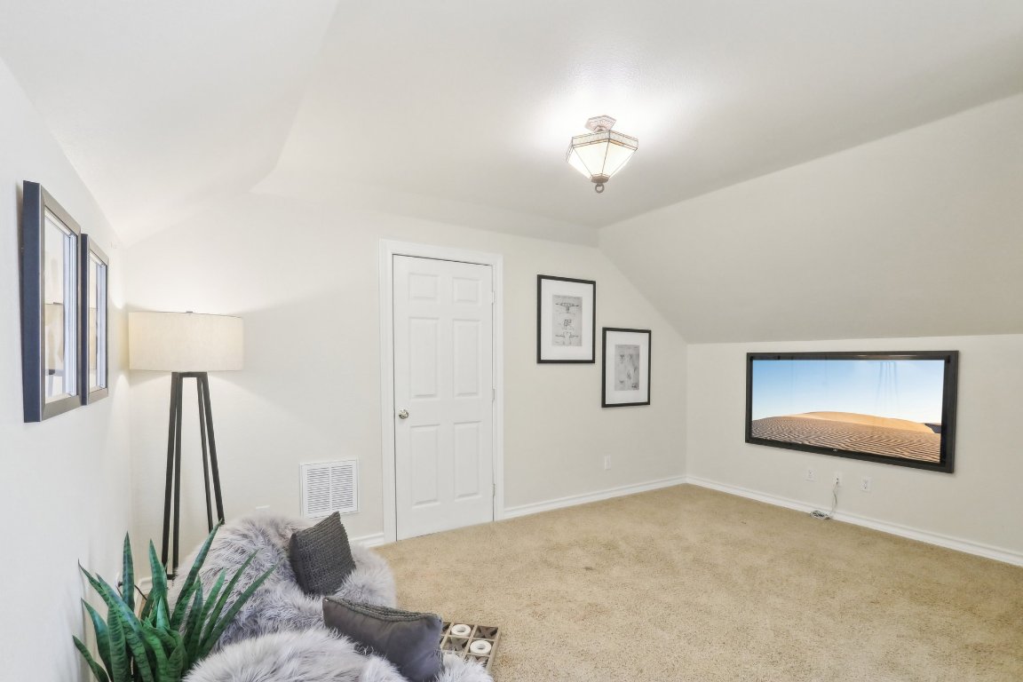 294 Logan Ranch Road Georgetown, TX 78628 - Photo 29 of 39 a bedroom with furniture and a chandelier