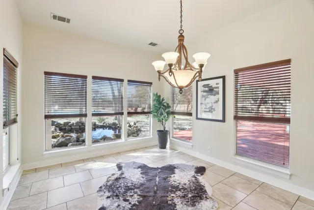 a kitchen with a stove a sink dishwasher a kitchen island with wooden cabinets and floor