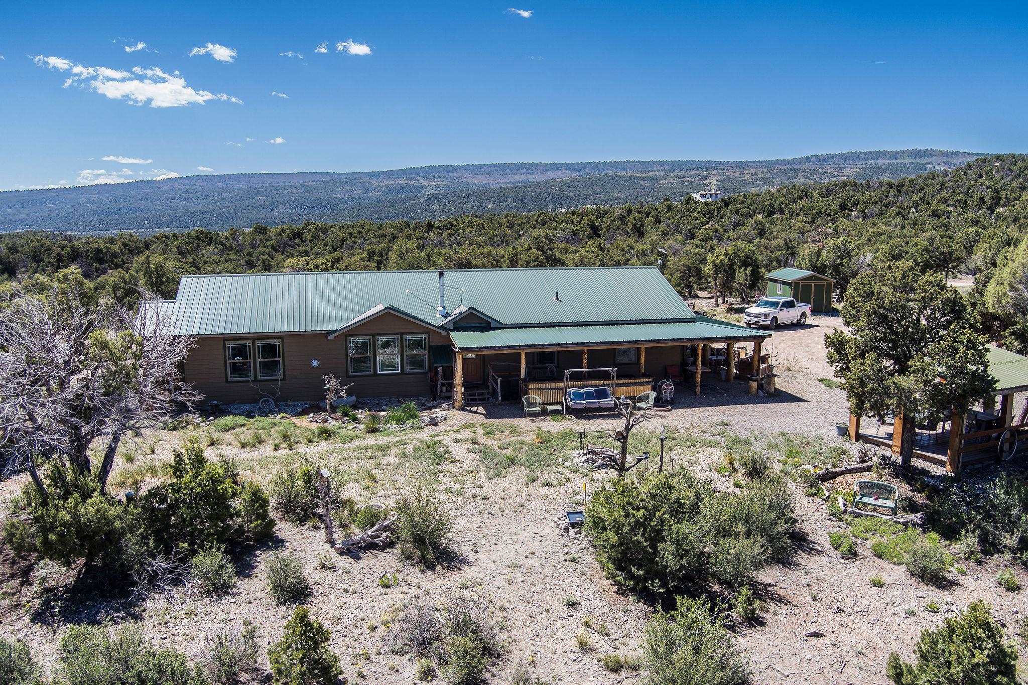 19958 Miller Canyon Ranch Road Glade Park, CO 81523 - Photo 1 of 42 a view of a house with a yard