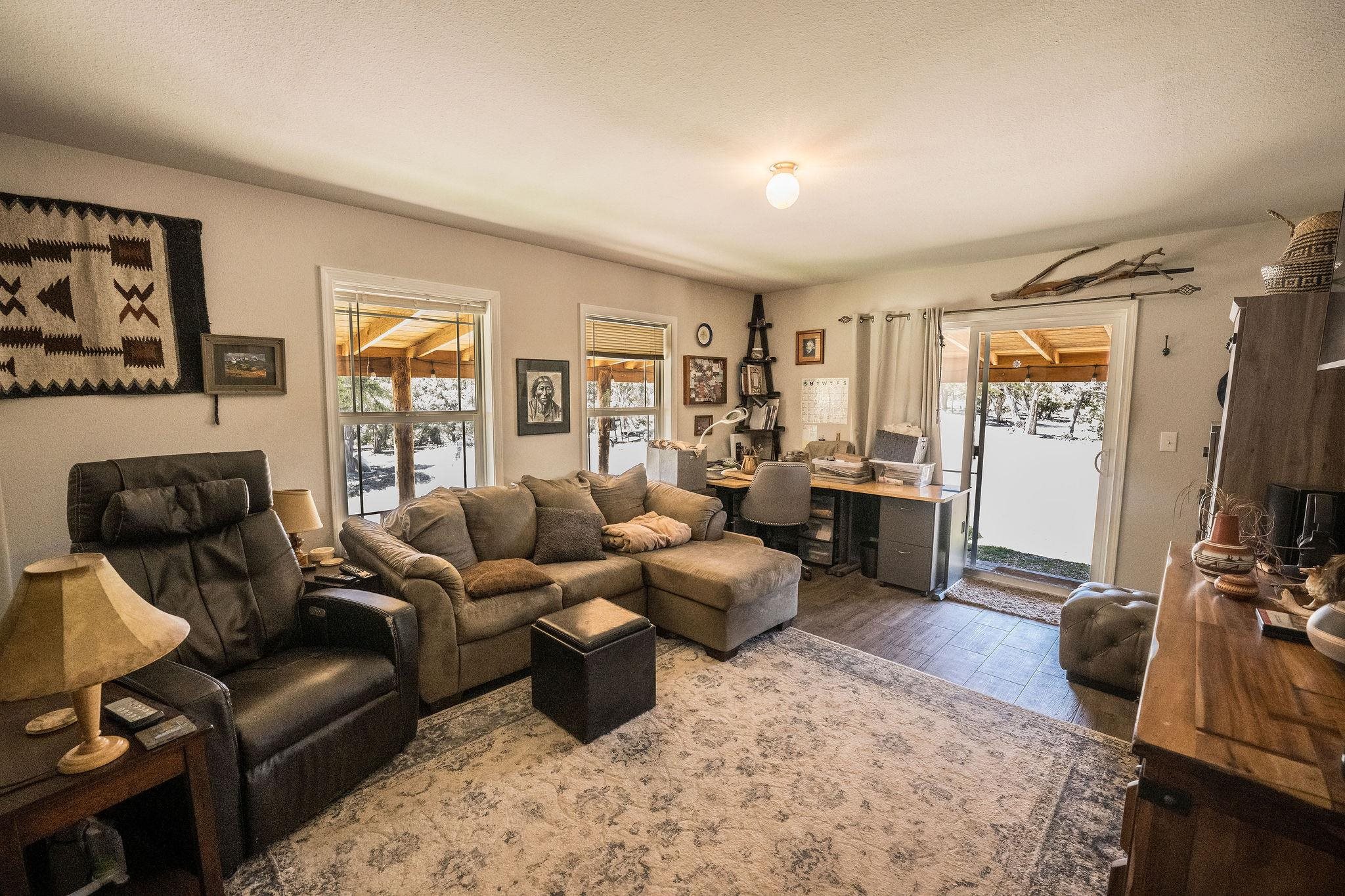 19958 Miller Canyon Ranch Road Glade Park, CO 81523 - Photo 15 of 42 a living room with furniture and a flat screen tv