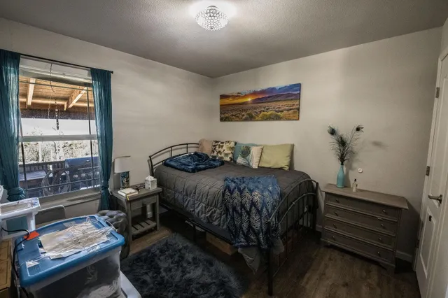 a bedroom with a bed and a window